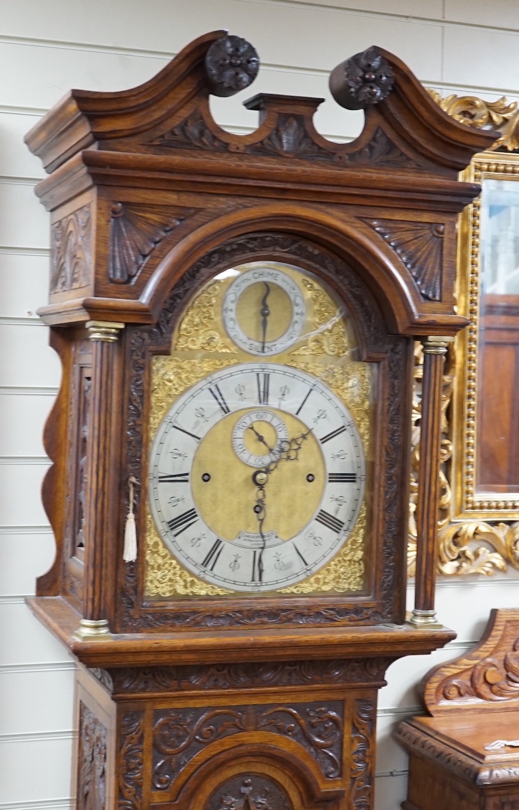 A late Victorian Camerer Cuss & Co carved oak chiming longcase clock, height 237cm *Please note the sale commences at 9am.
